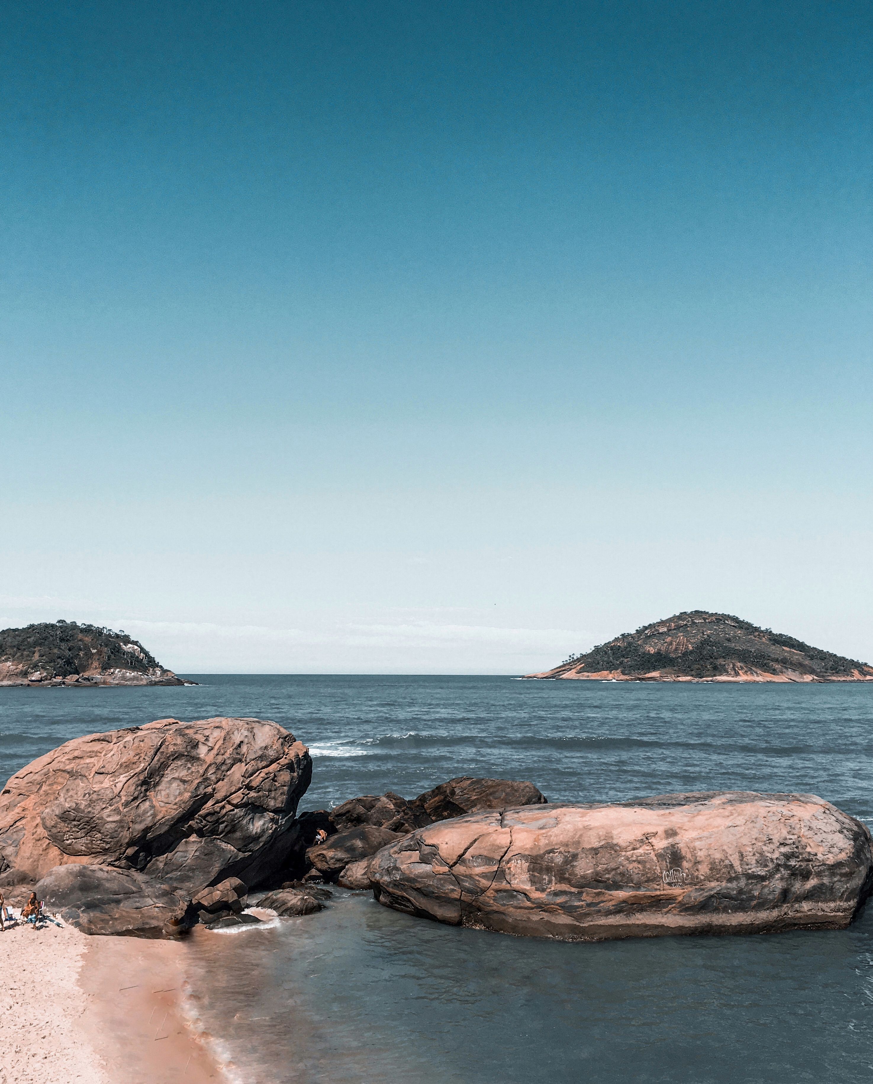 A Rock Formation on Sea Under the Blue Sky · Free Stock Photo