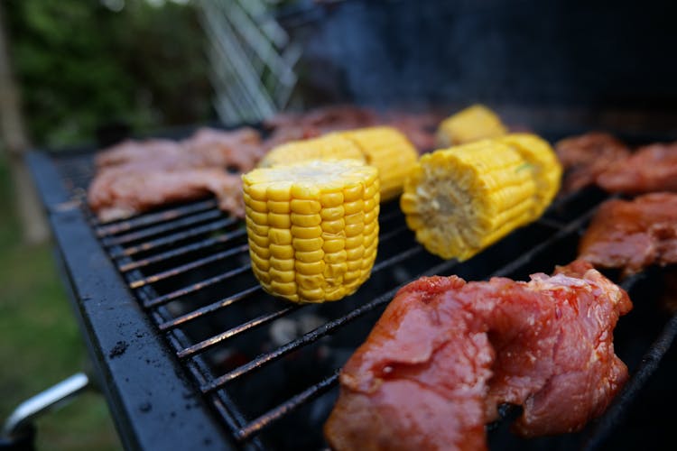 Fresh Beef And Sliced Corn On The Cobs On A Griller