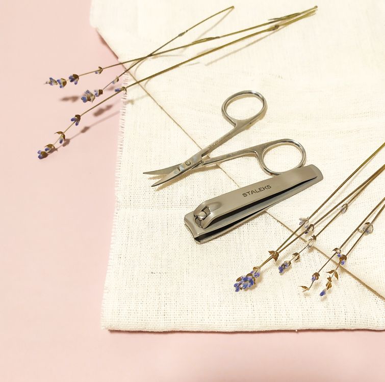 Nail care tools including nail clipper and scissors arranged aesthetically