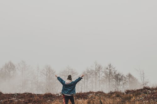 Person in Blue Jacket Standing