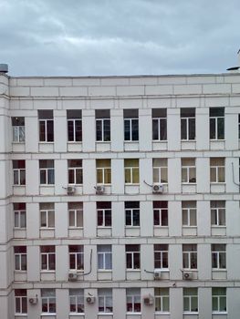 A modern building exterior showcasing uniform windows with urban architectural design.