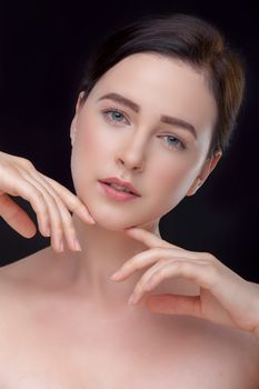 Elegant close-up portrait of a woman posing against a black backdrop. Perfect for beauty or fashion themes.