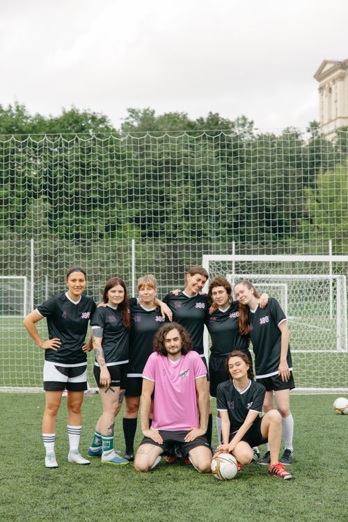 Free A cheerful group of women soccer players posing together on a field, promoting teamwork. Stock Photo
