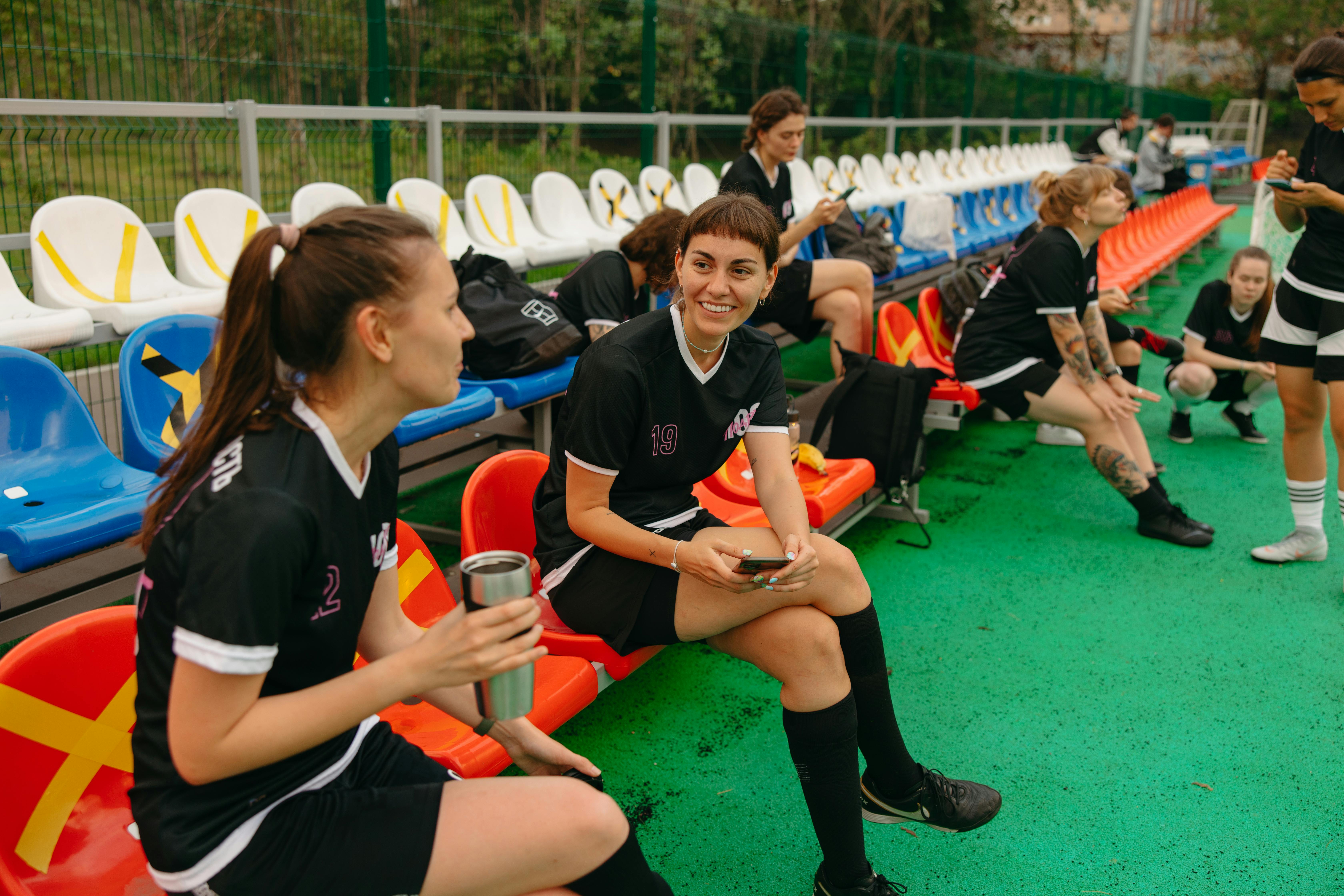 Athletes Resting on Benches · Free Stock Photo