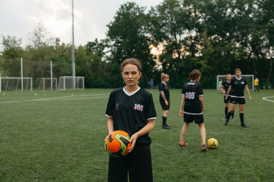 Women soccer team practicing on an outdoor field, ready for a match.