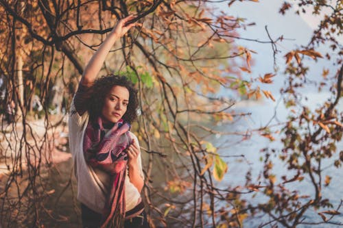 Wanita Yang Berdiri Di Samping Pohon Telanjang Di Dekat Perairan