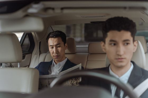 Passenger reading in the back of a car — photo by Ron Lach on Pexels