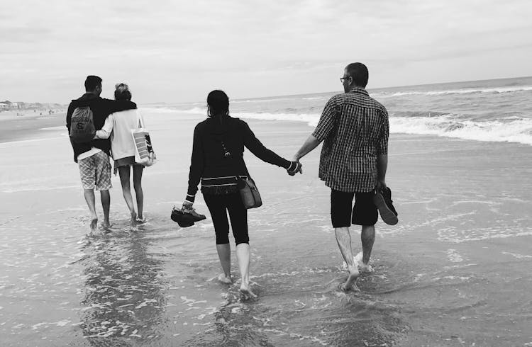 Gray Scale Of Two Couples On The Beach