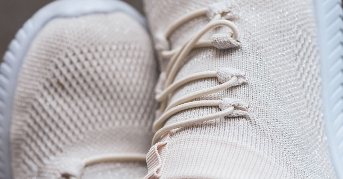 Close-up of trendy beige sneakers showcasing texture and style. Perfect for fashion enthusiasts.