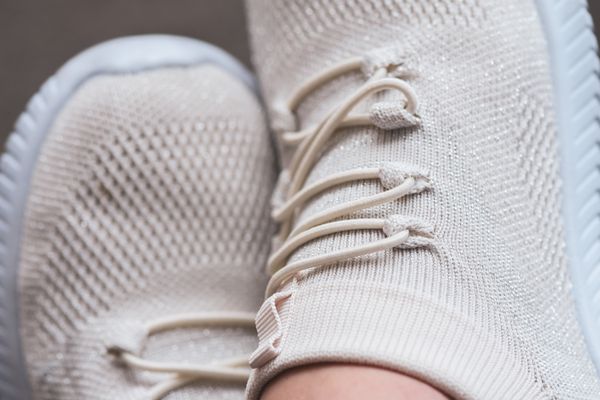 Close-up of trendy beige knit sneaker showcasing texture and comfort