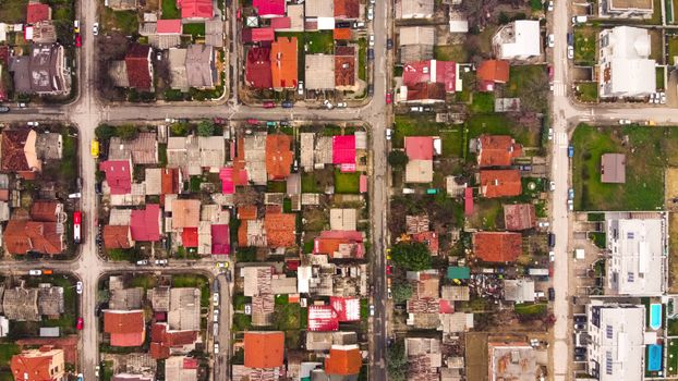 Vibrant aerial view of residential neighborhood in Lisiche, North Macedonia showcasing colorful rooftops and streets.