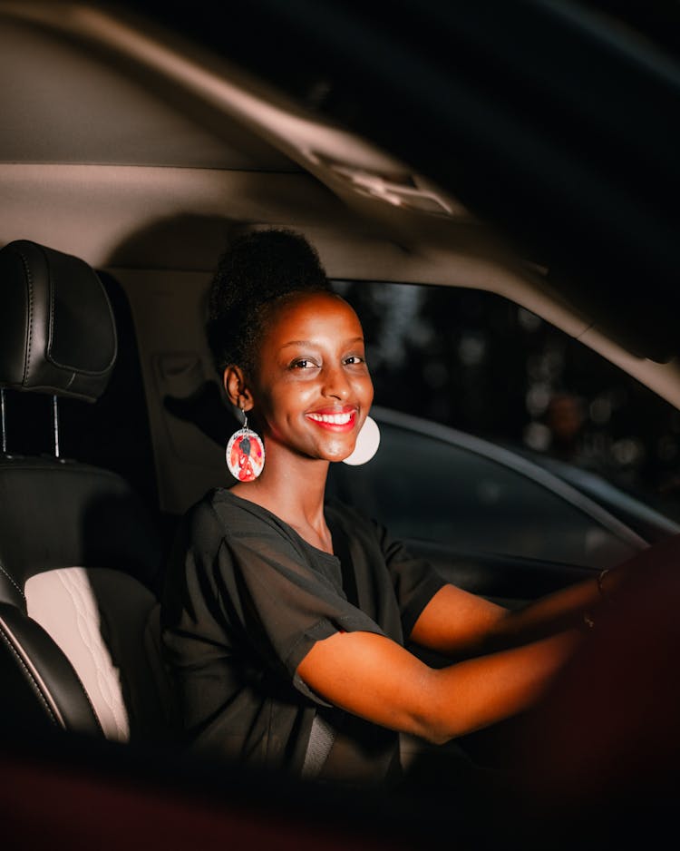 Pretty Smiling Woman Driving Car 