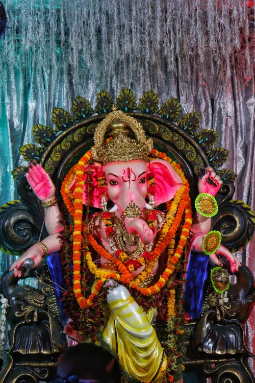 Free Vibrant image of a Ganesha statue adorned with traditional garlands. Stock Photo