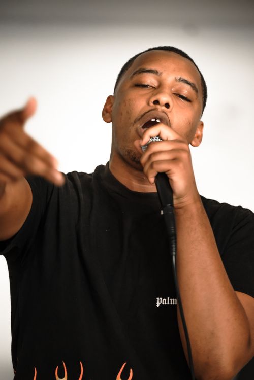 Free Passionate black male rapper in black T-shirt performing with microphone. Stock Photo