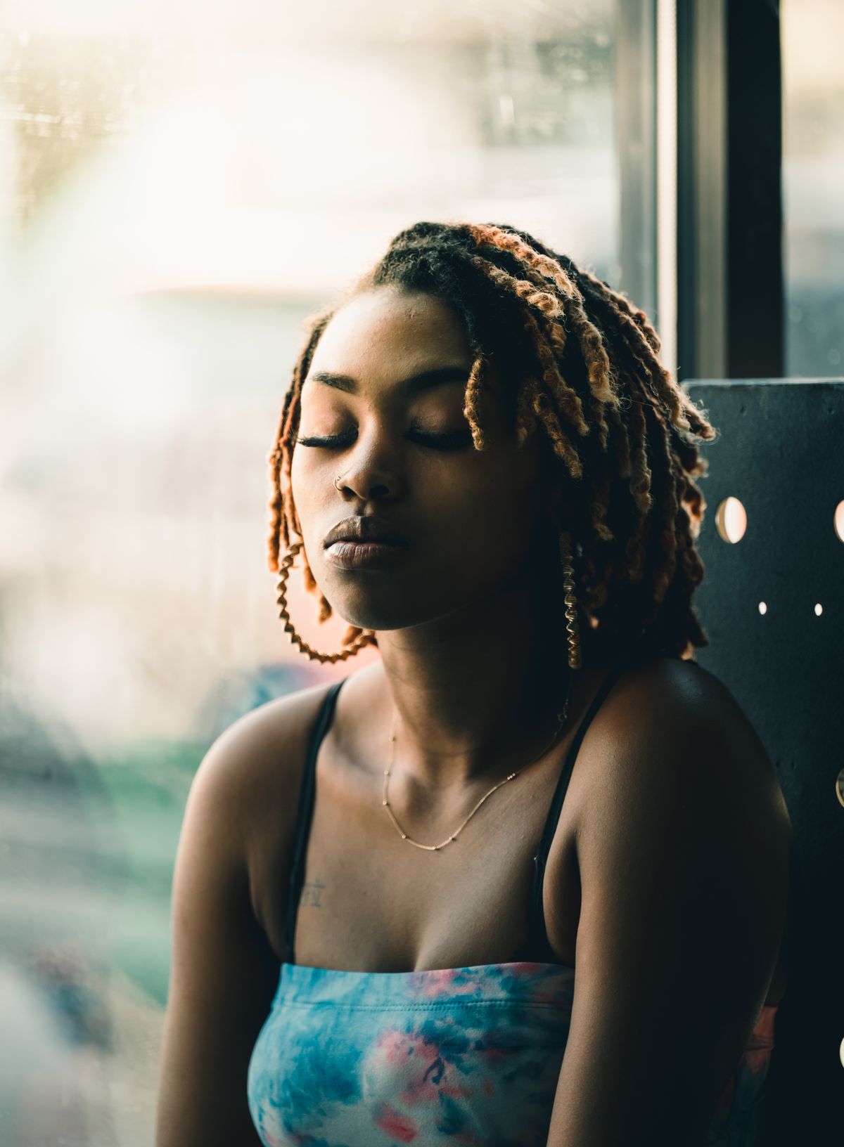 African American woman wearing locs — how to sleep with butterfly locs
