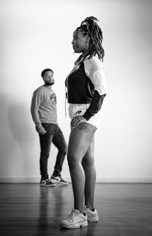 Man Standing Looking at the Woman with Dreadlocks Hair 