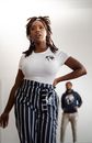 A Woman in White Shirts and Striped Pants