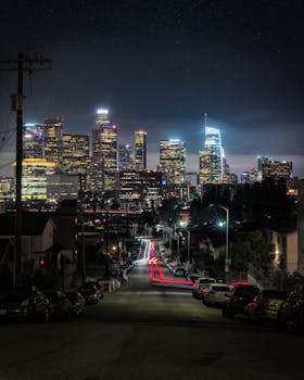 Stunning night view of the illuminated Los Angeles skyline with long exposure streetlights.