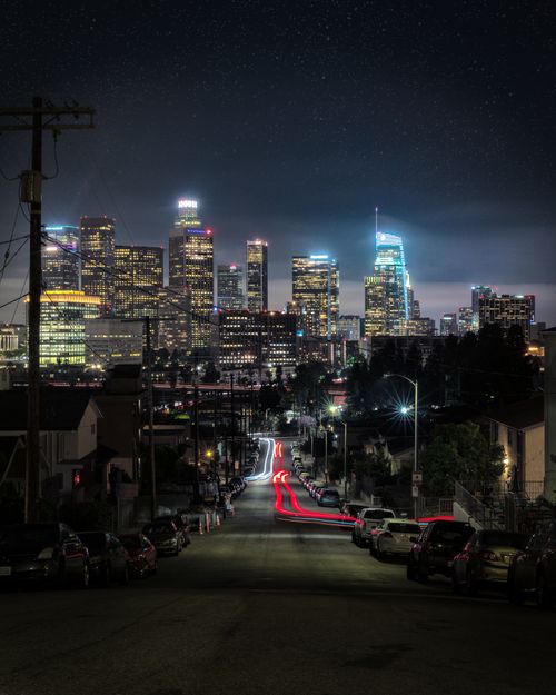 Free Stunning night view of the illuminated Los Angeles skyline with long exposure streetlights. Stock Photo