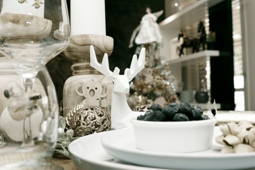 Free A sophisticated Christmas table setting featuring decorations, blueberries, and festive ornaments indoors. Stock Photo