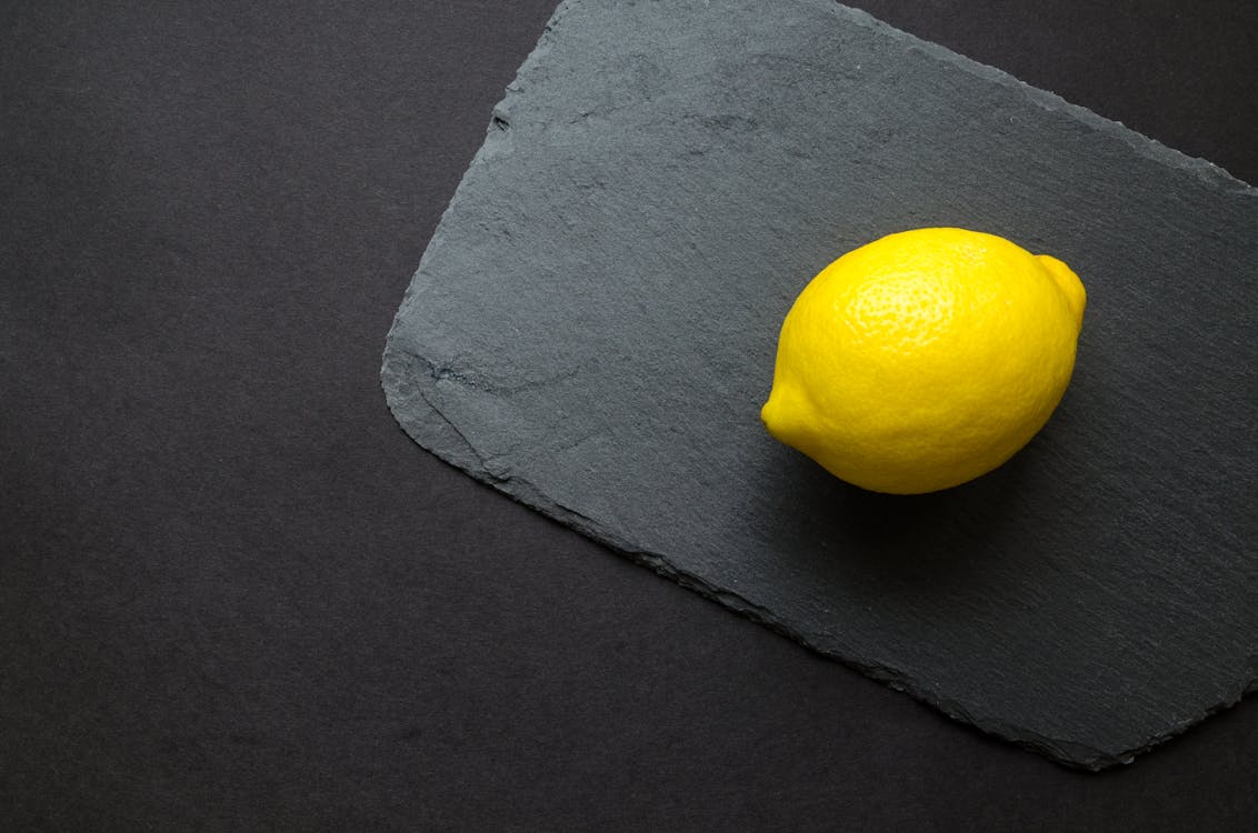 Free Photo of Yellow Lemon on Gray Surface Stock Photo
