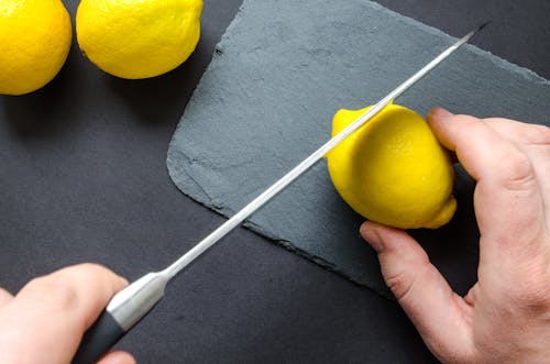 Free Photo of Person Slicing Lemon Stock Photo