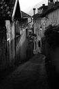A Narrow Slanted Alley Between Concrete Houses