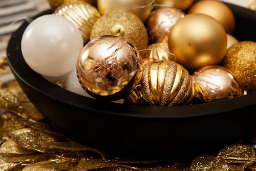 Gold Christmas Balls in a Black Bowl