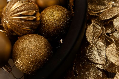 Free A close-up shot of glittering golden Christmas ornaments and decorations, perfect for a festive atmosphere. Stock Photo