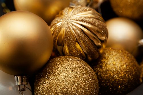 Free Close-up of glittering golden baubles, perfect for holiday decoration themes. Stock Photo