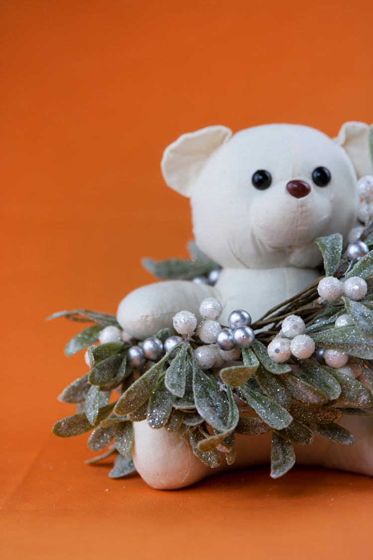 A Teddy Bear Wrapped In Mistletoe Wreath