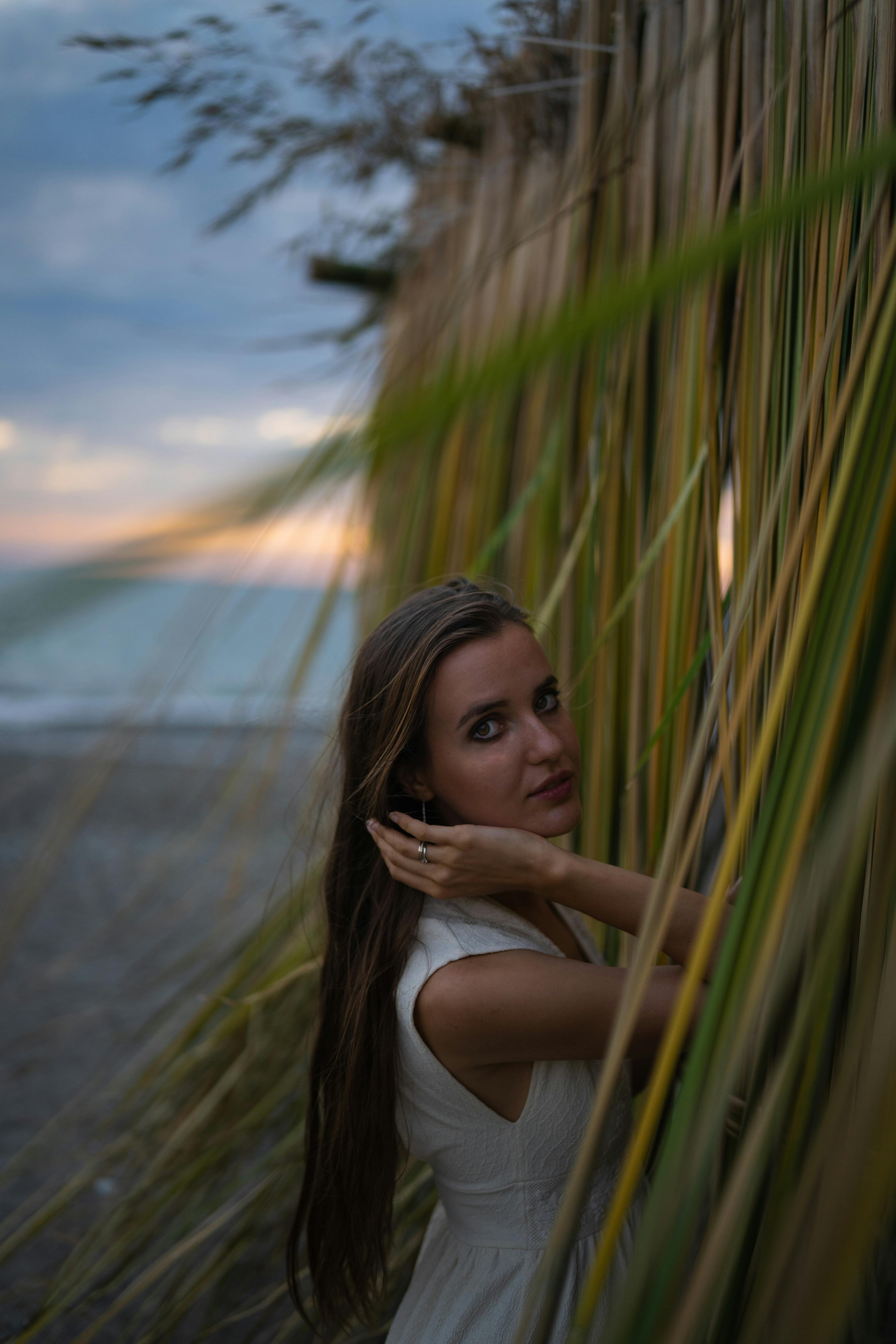 woman in the beach posing with hand near her face