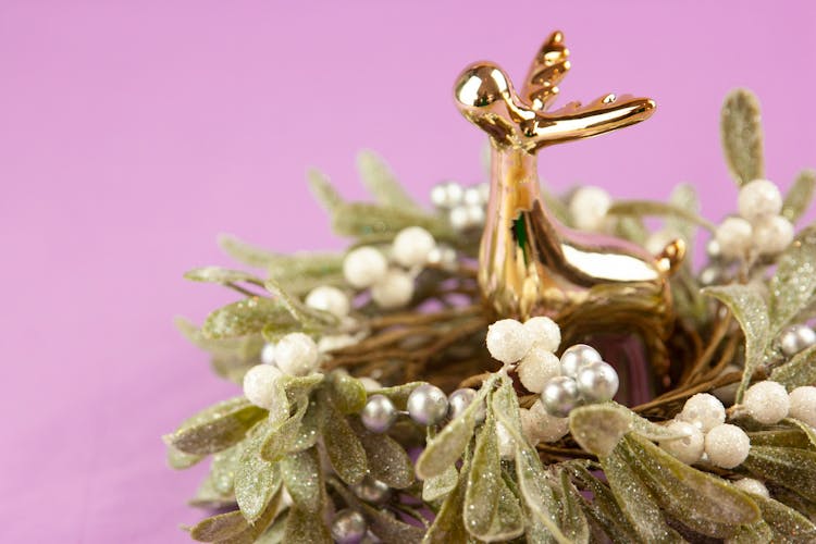 A Golden Reindeer Figurine On A Mistletoe Wreath