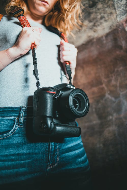 Woman Carrying a Black Nikon Dslr Camera