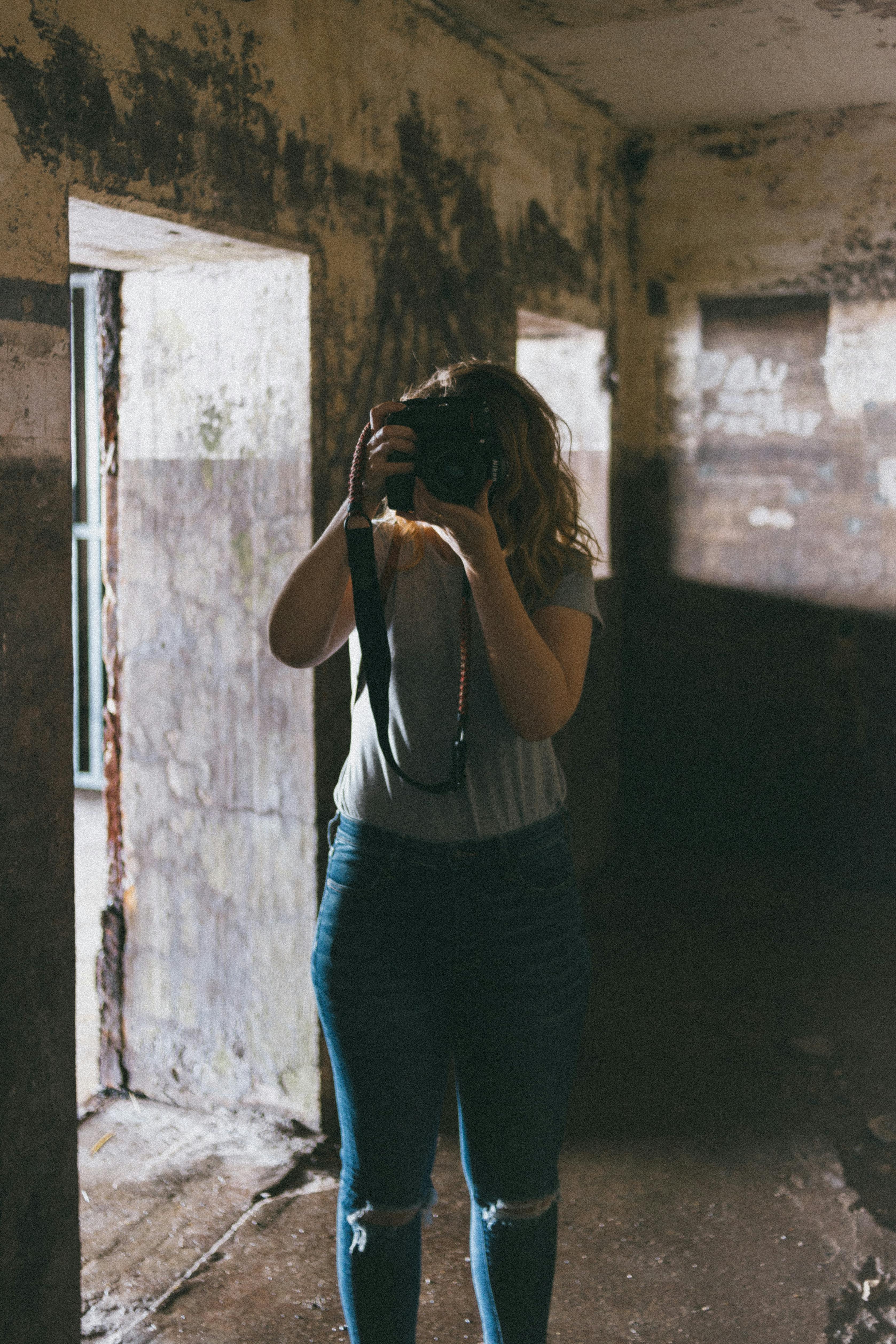 Woman in Gray Sweater and Blue Denim Jeans · Free Stock Photo