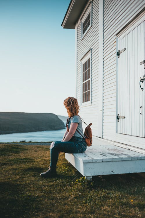 A Person Sitting on a Wooden Foyer