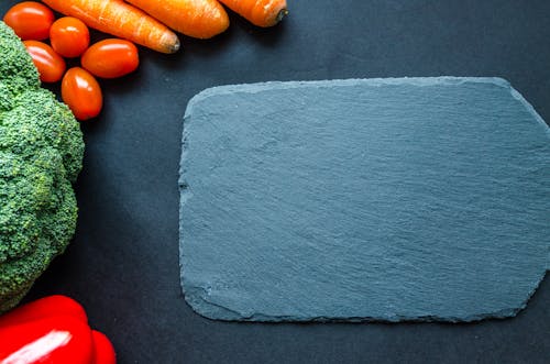 Gray Chapping Board Beside Vegetables