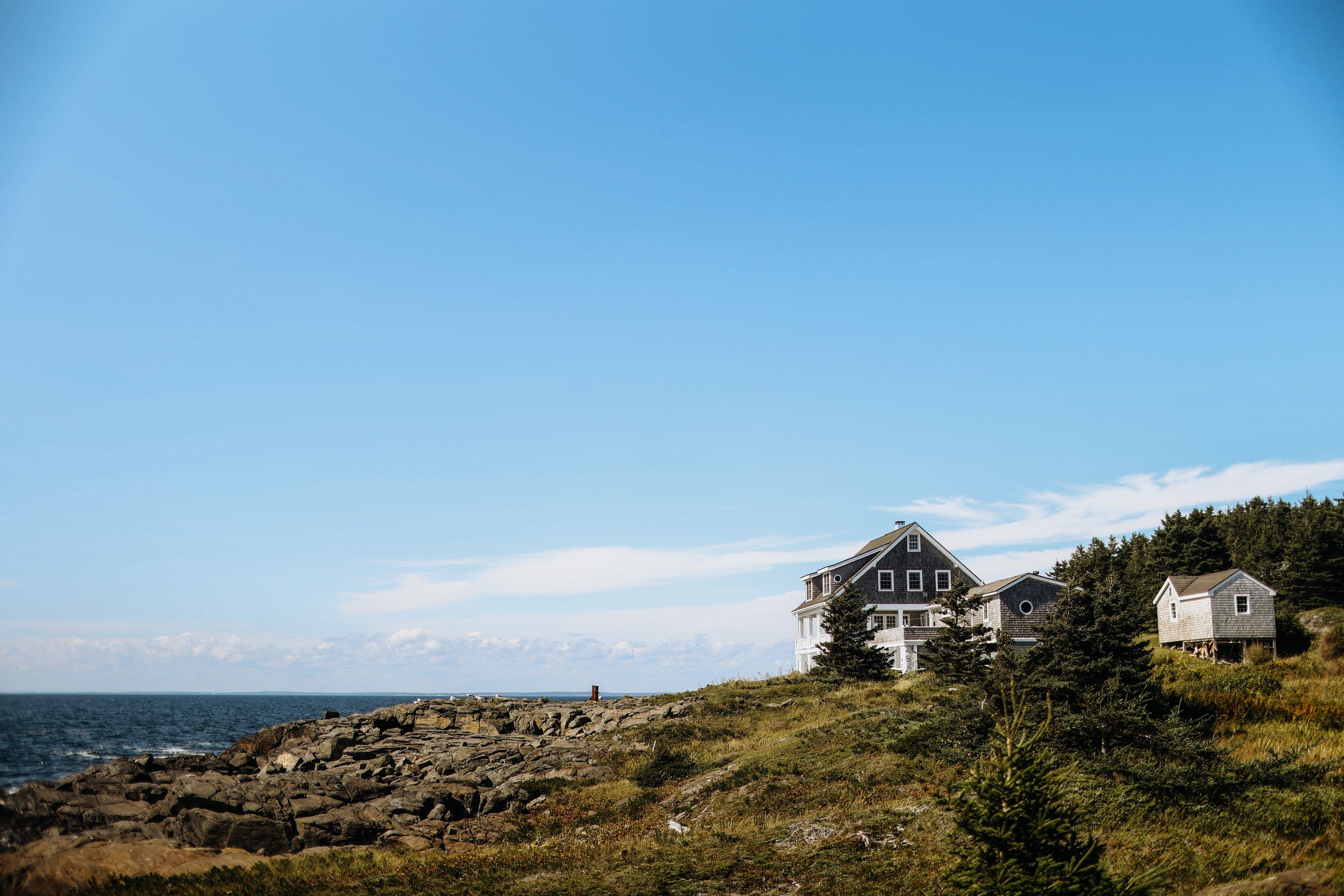 Maine: Coastal houses and rocky shoreline on Monhegan Island, Maine