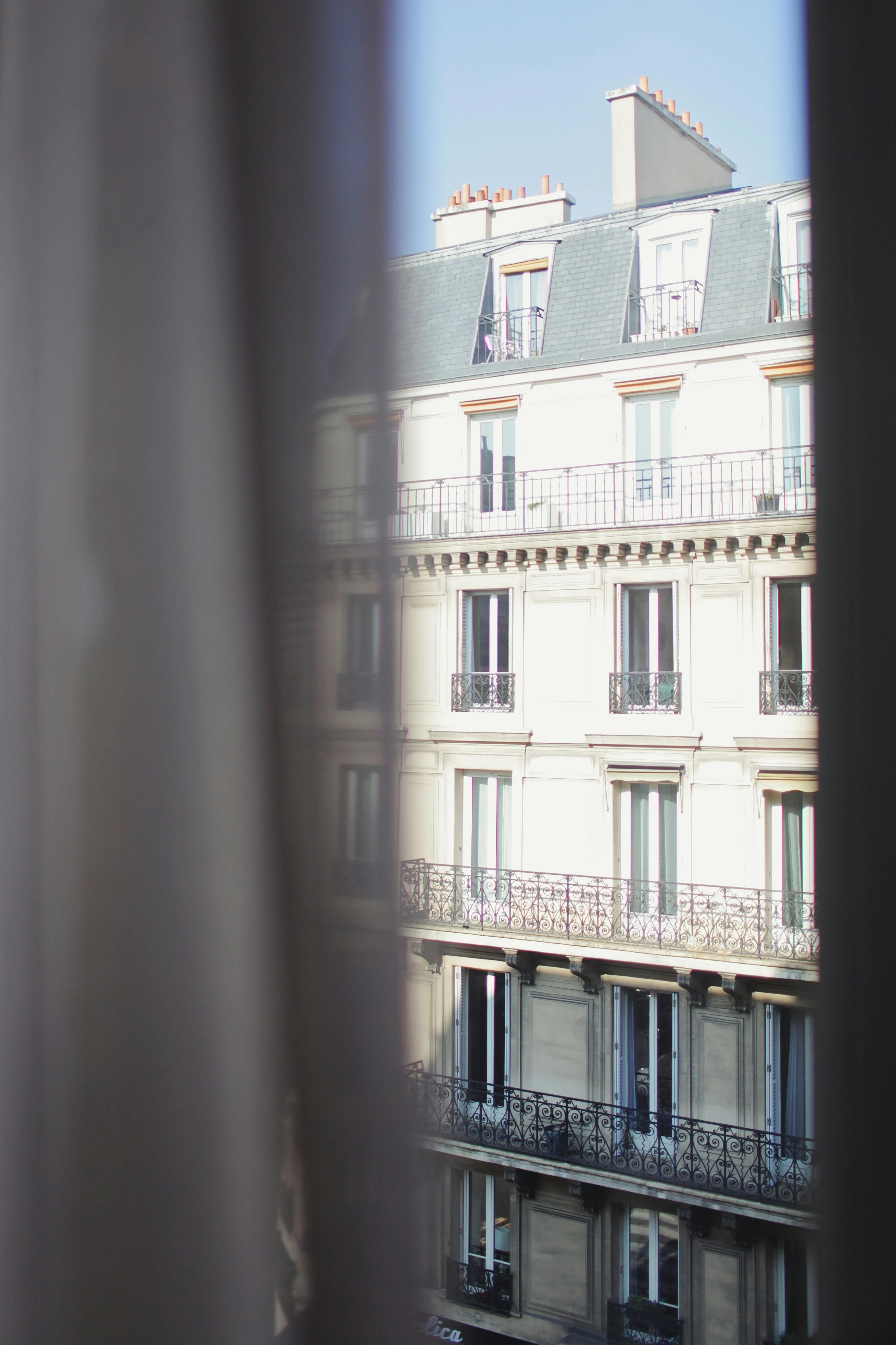 through window view of hotel on bright day