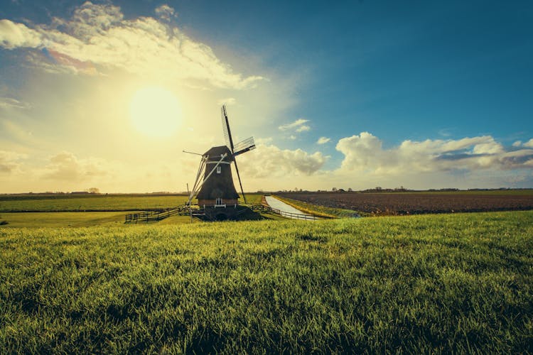 Vintage Black Windmill During Sunset