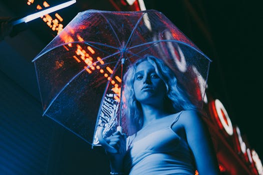 Portrait of a woman under umbrella with neon lights in the city at night.