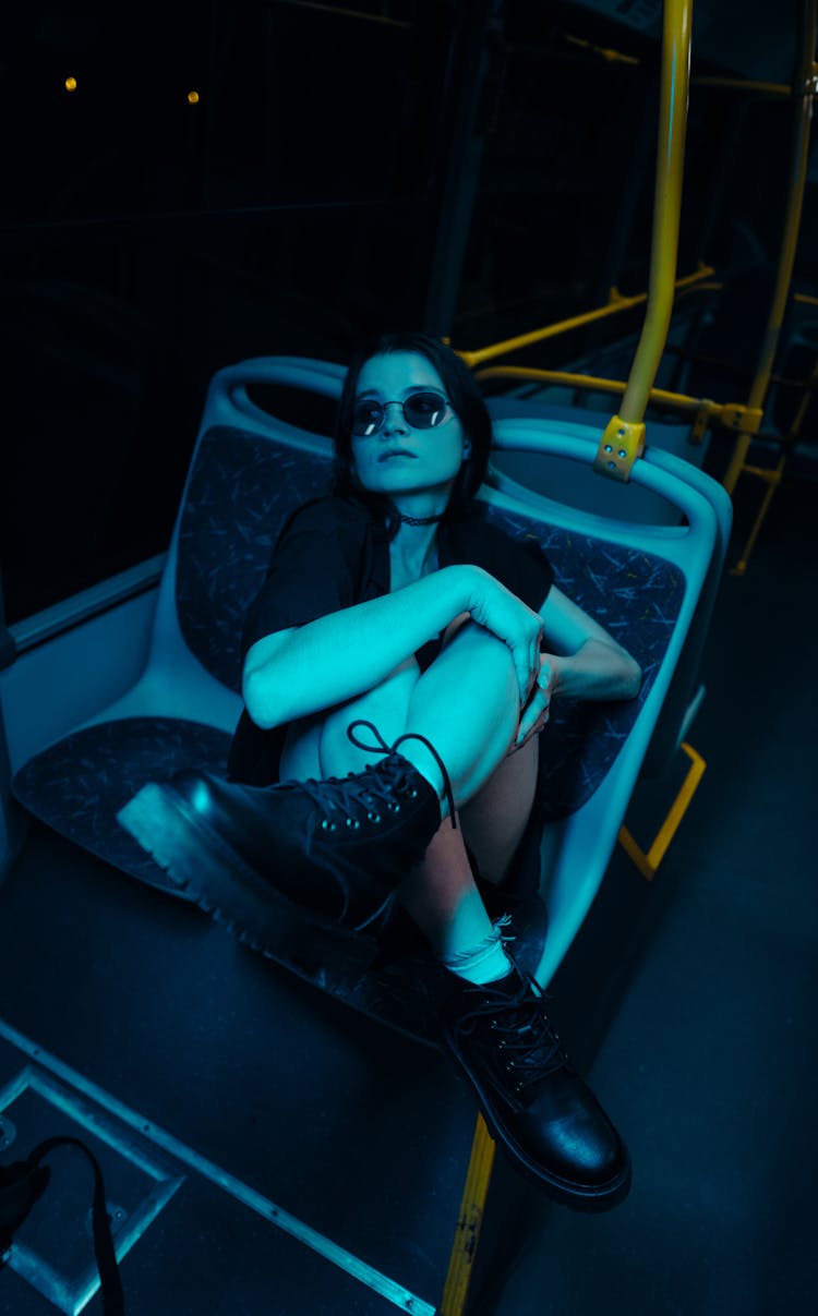 Woman Posing On Bus At Night