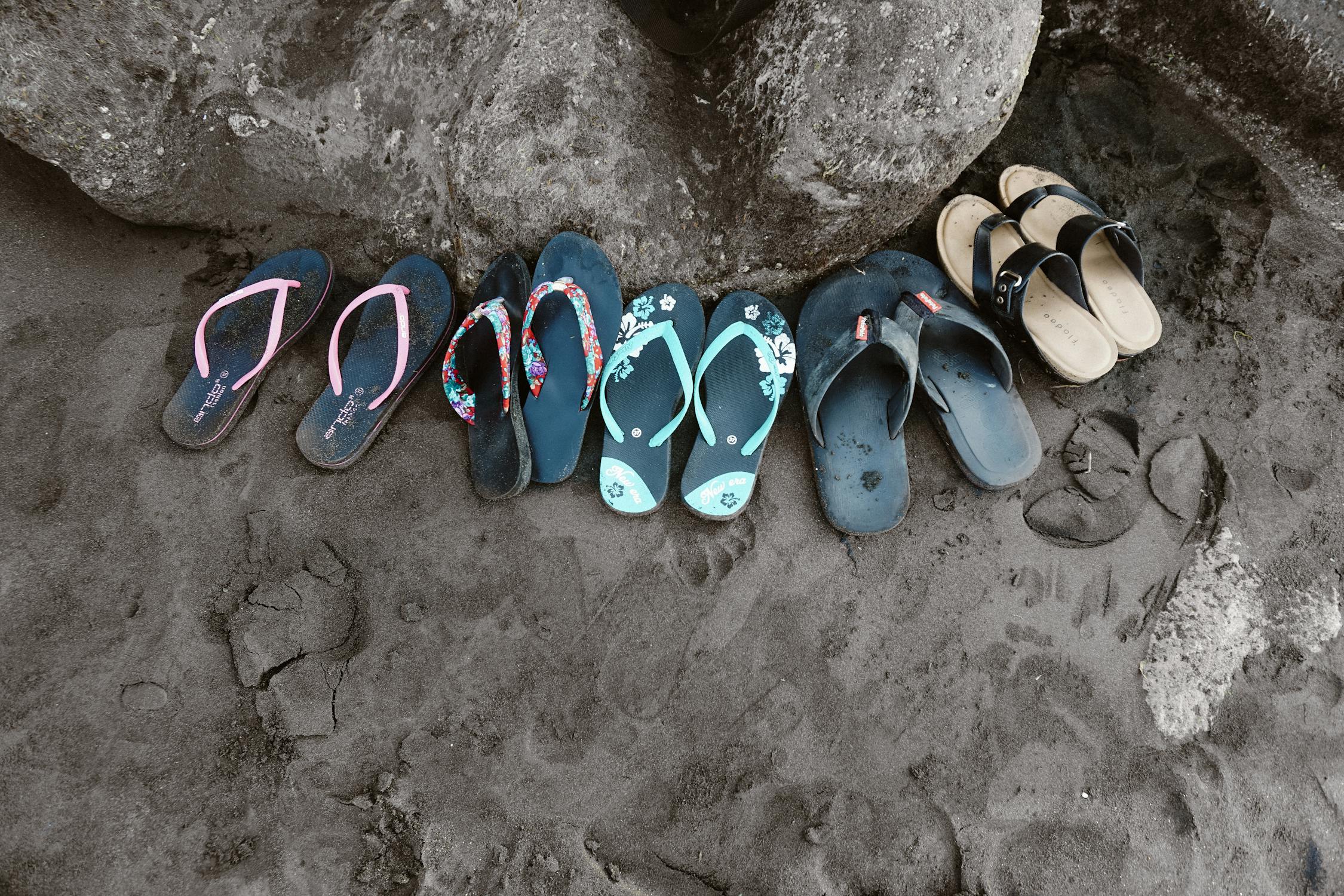 Assorted Flipflops on Sand · Free Stock Photo