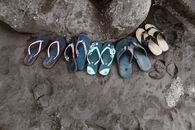 Assorted Flip-flops on Sand