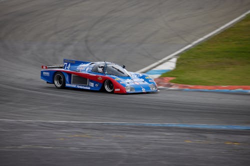 Photo of Red and Blue Race Car on Road