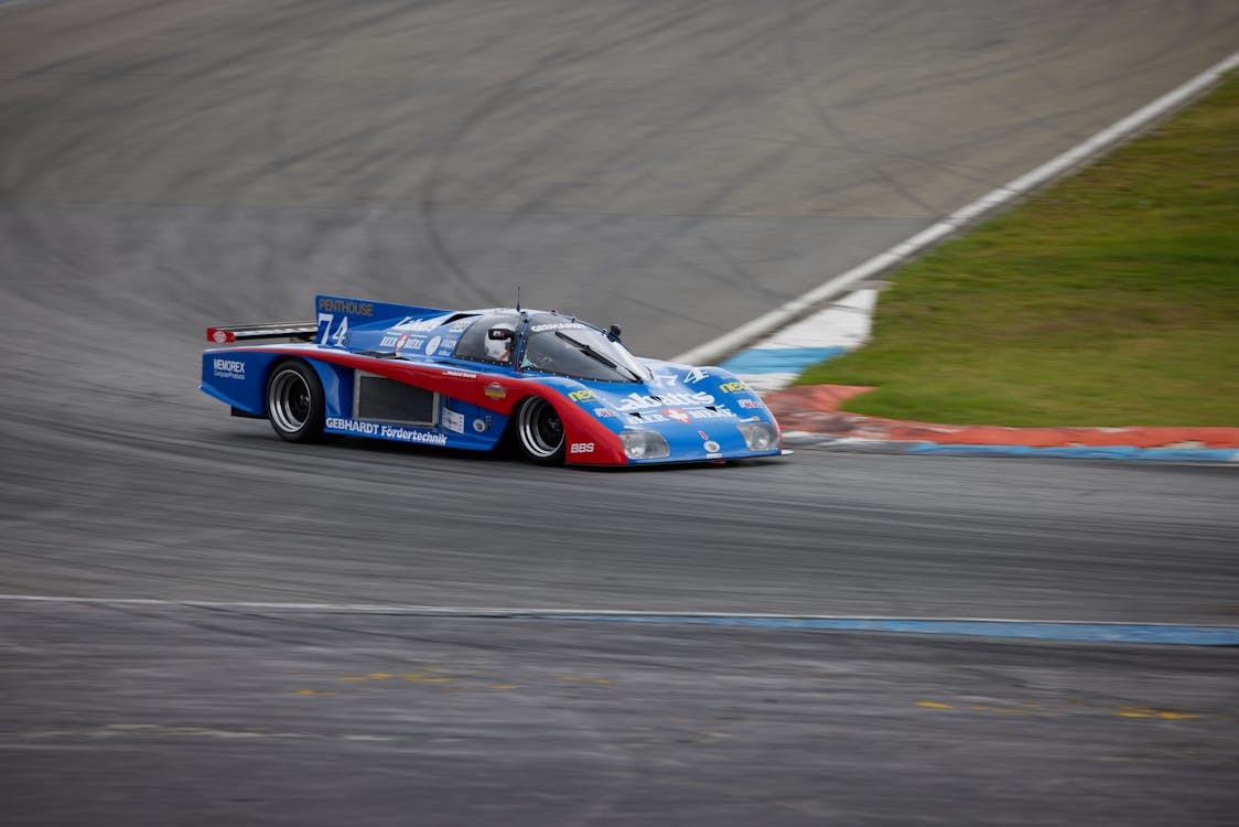 Photo of Red and Blue Race Car on Road