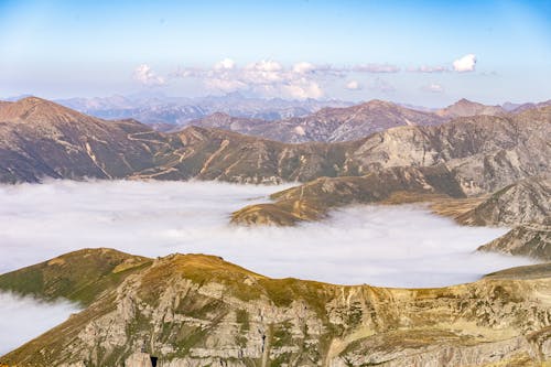 Aerial Photography of Cloudy Mountains under the Blue Sky