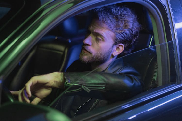 Man In Black Leather Jacket Driving Car