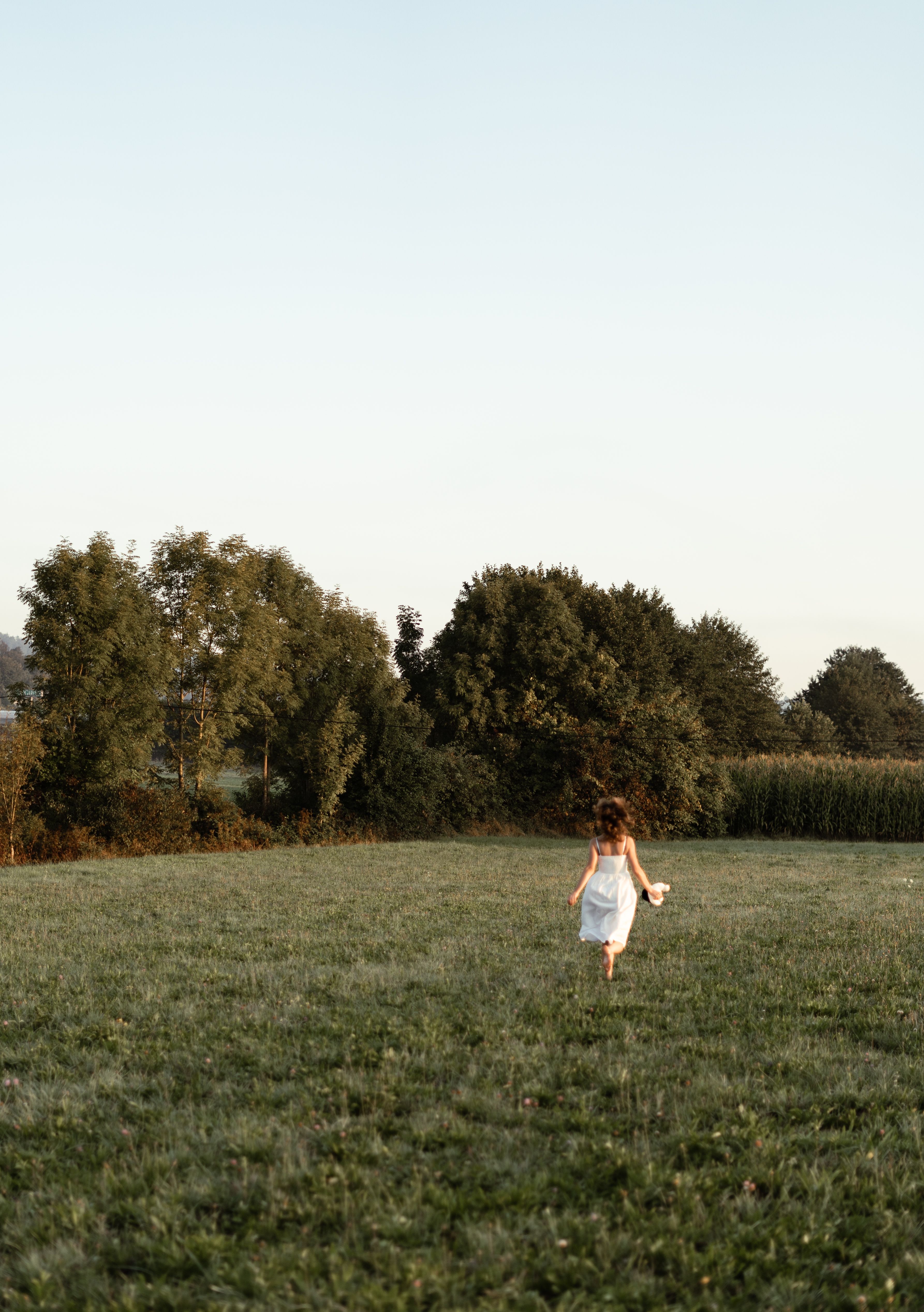 A Person in White Walking on Green Grass · Free Stock Photo
