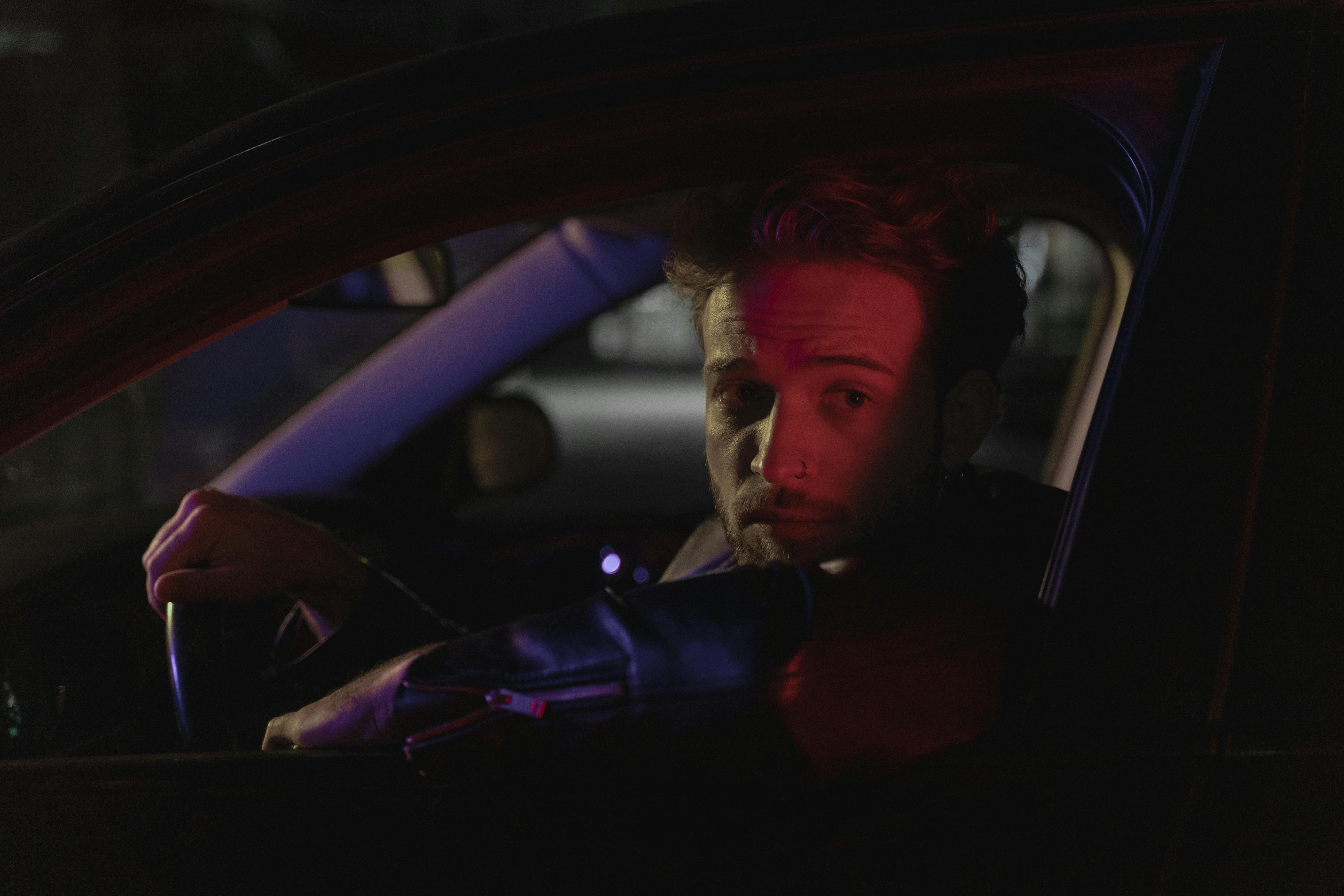 woman in purple jacket inside car